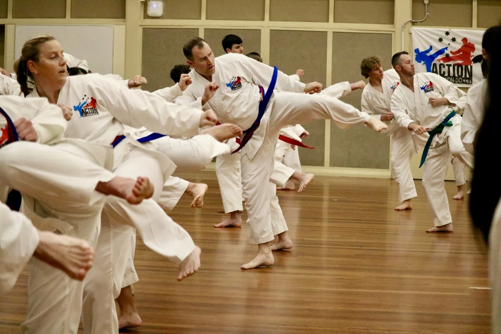Action Tae Kwon-Do adults students at a grading.