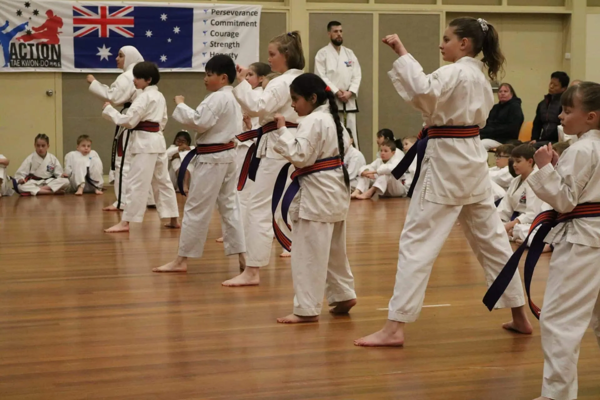 Action Tae Kwon-Do children students performing at a grading.